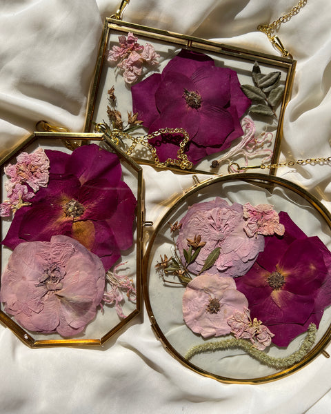 Brass hanging flower frame displaying pink-themed preserved blooms, handcrafted by Happihome for timeless floral wall décor.